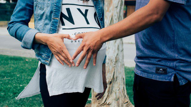 b2ap3_medium_pregnant-woman-holding-her-tummy-together-with-a-man-beside-208509