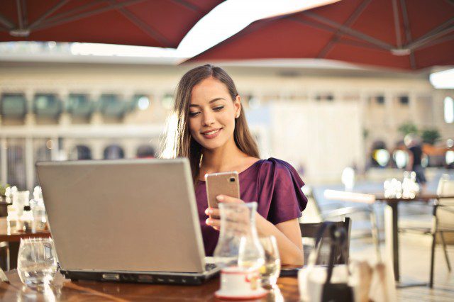 b2ap3_medium_woman-wearing-purple-shirt-holding-smartphone-white-sitting-826349