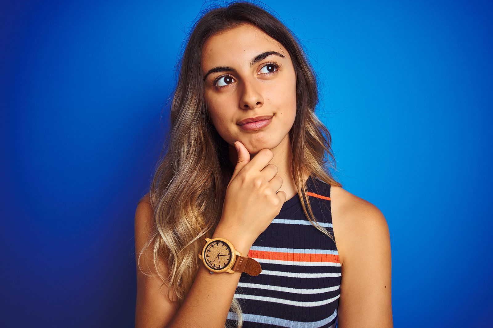Young beautiful woman wearing stripes t-shirt over blue isolated