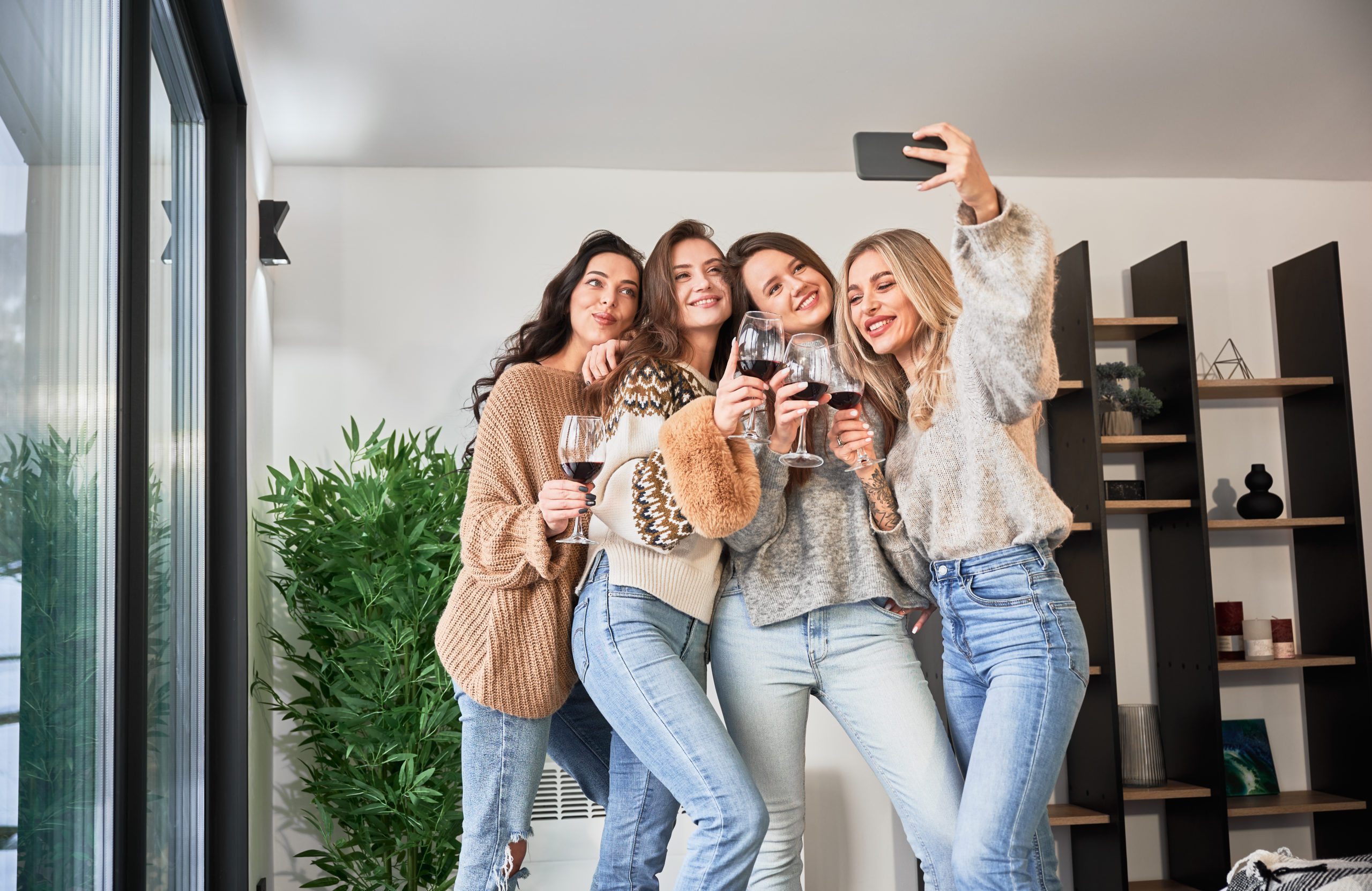Young Women Enjoying Winter Weekends Inside Contemporary Barn Ho