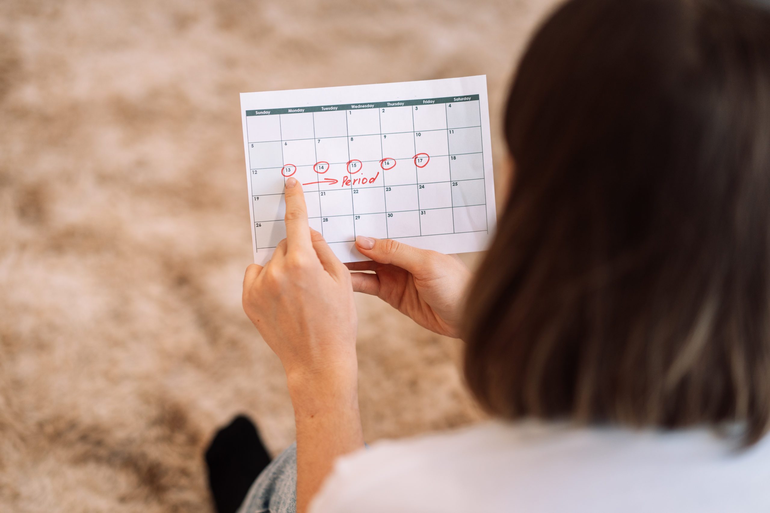 Lady Looks At The Days In The Calendar Menstrual Cycle